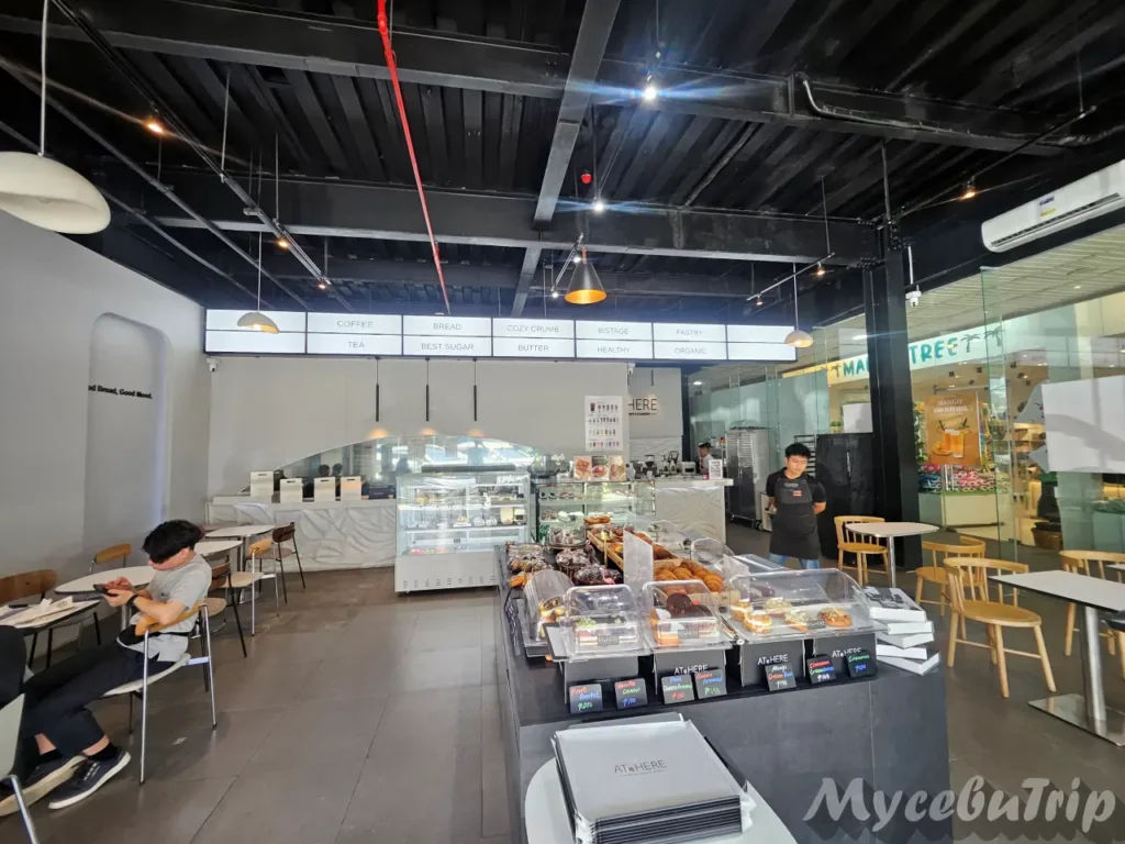 Spacious and modern interior seating area of AT@HERE Bakery Cafe located in LG Garden Walk.