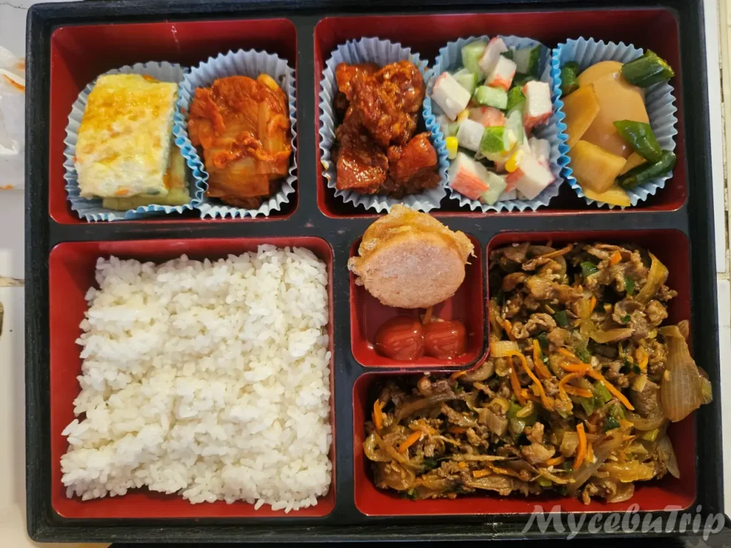 A delicious Korean lunch box with Soy-marinated Pork (Bulgogi) and fresh side dishes provided for Cebu private hopping tours.