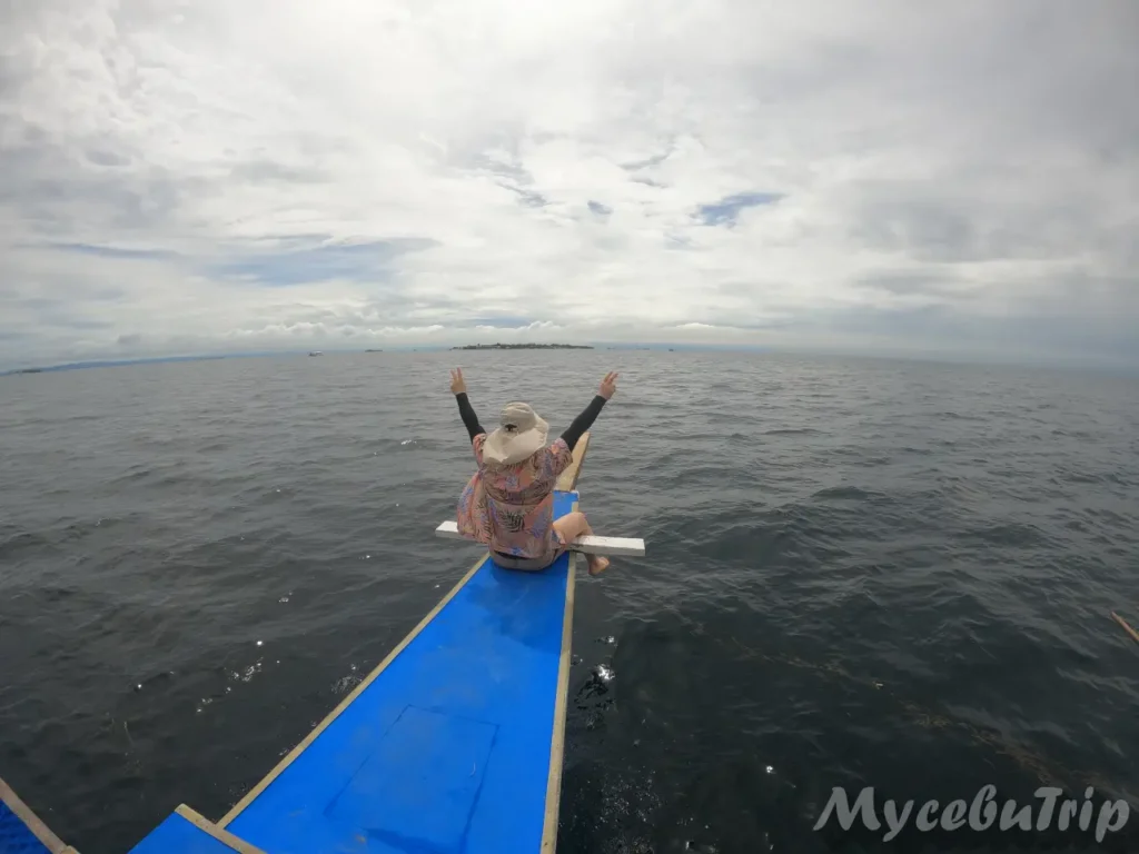 Tourist relaxing on a traditional Banca boat during Cebu island hopping tour