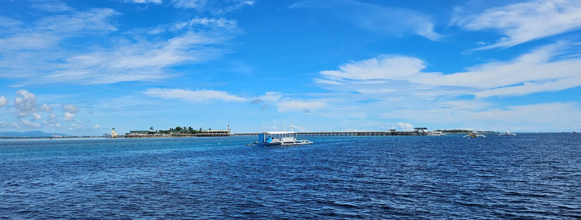 Scenic view of Nalusuan Island pier and private banca boat in Cebu