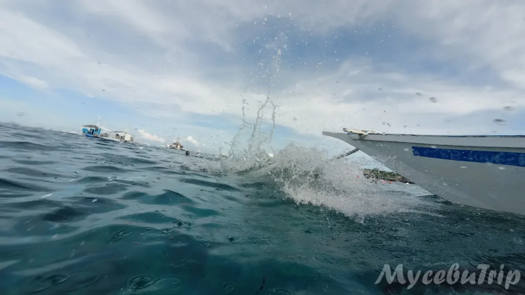 Splashing water waves while riding a Banca boat in Cebu