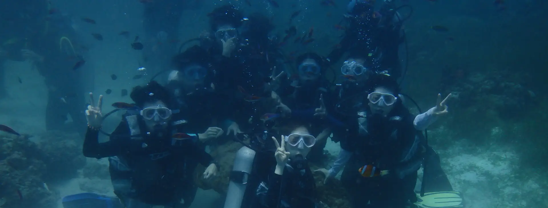 Large group of friends enjoying a safe introductory scuba dive in Mactan
