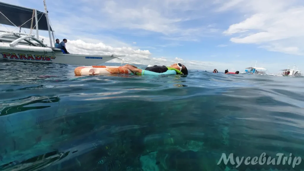 Relaxing and napping on a floating tube at Hilutungan