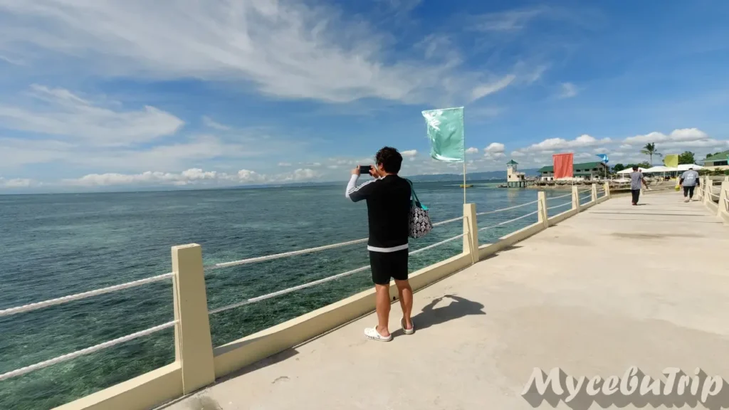 Taking photos of the seascape at Nalusuan Marine Sanctuary pier