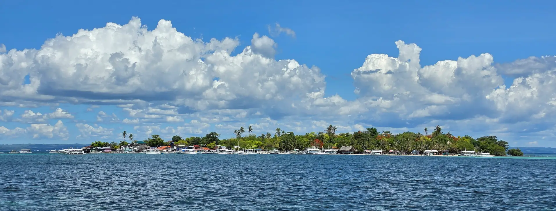 Cebu Nalusuan & Caohagan Island Hopping Tour — panoramic view of Caohagan's fishing village and boats